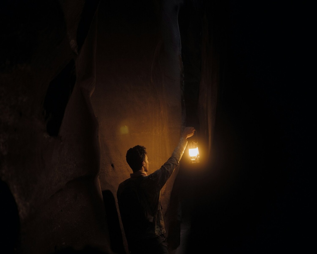 a man standing in a softly lit room for trauma therapy in Raleigh, NC